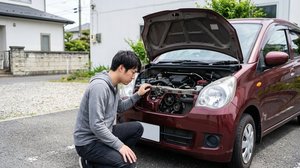 ボンネットを開けてエンジンルームのベルト周辺を点検する様子
