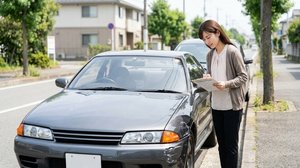 事故で破損した車の損傷状況を確認する場面